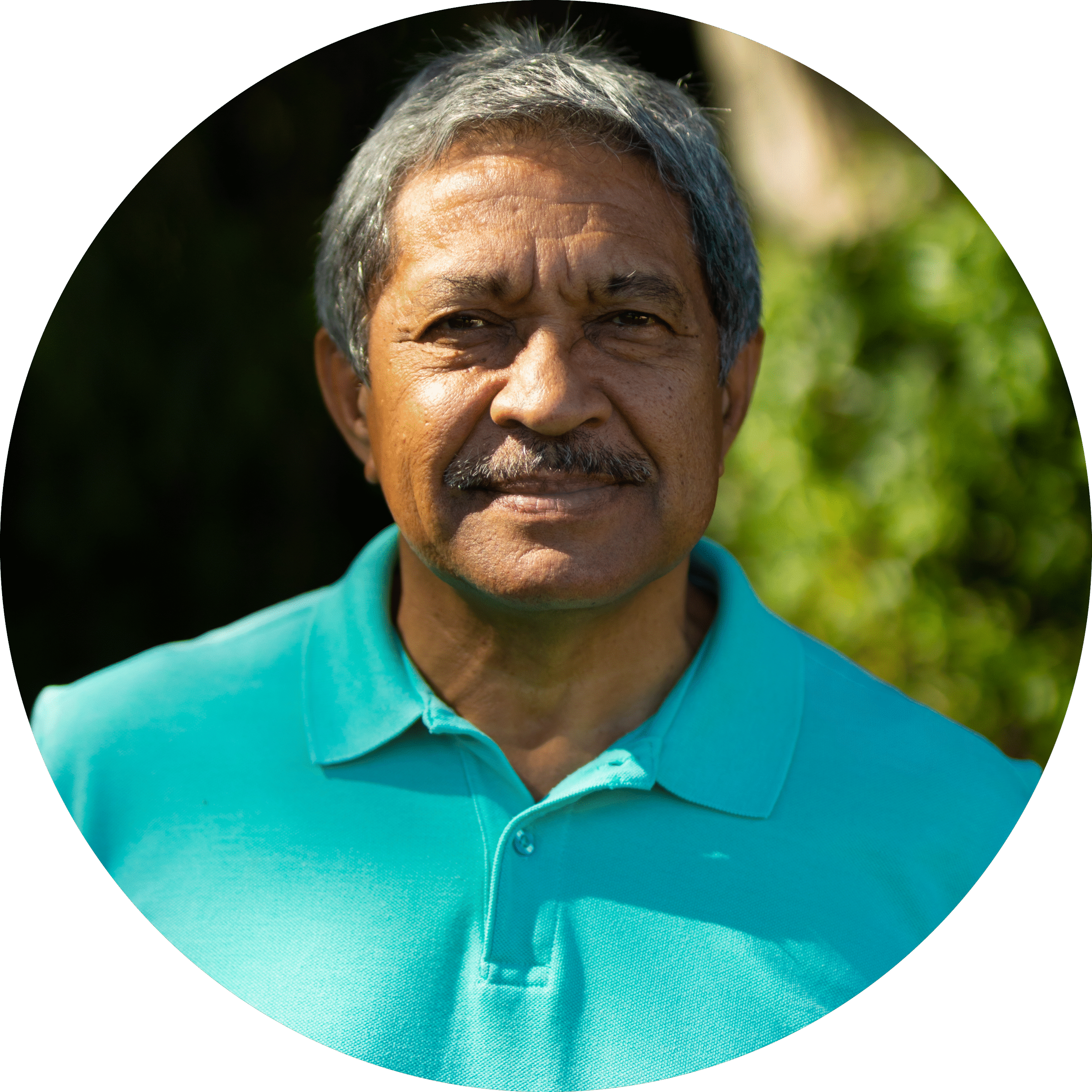 portrait smiling biracial senior man wearing blue t shirt with gray hair standing park